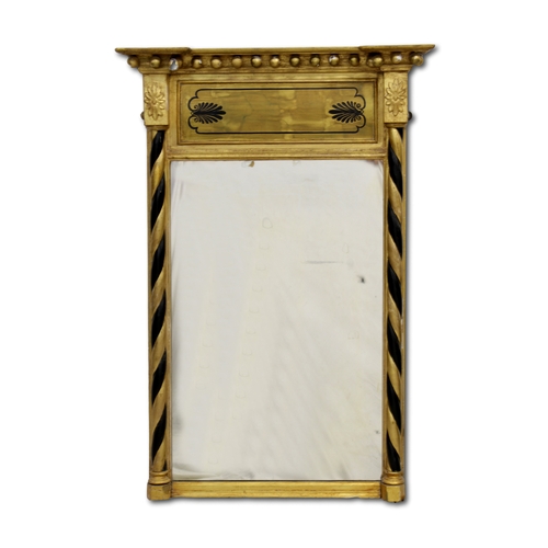 659 - A Regency parcel gilt and black pier mirror with foliate decorated frieze and solomonic columns bene... 