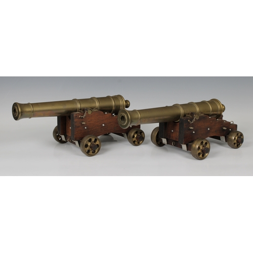 104 - A pair of early 20th century bronze table top model signalling cannons, the ringed barrels mounted o... 