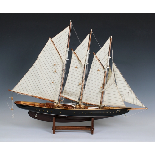 23 - A wooden model of a three masted, gaff rigged Atlantic schooner, 60cm x 72cm on wooden stand