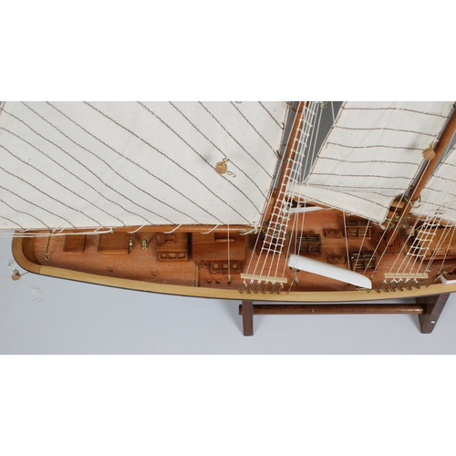 23 - A wooden model of a three masted, gaff rigged Atlantic schooner, 60cm x 72cm on wooden stand