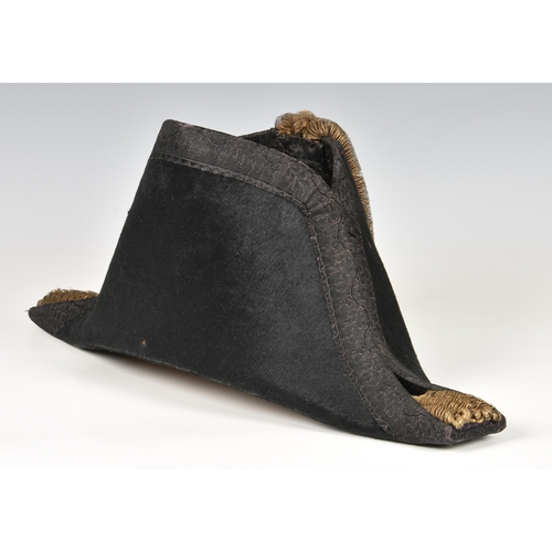 94 - Black felt Royal Navy midshipman's bicorn hat, owner's name inscribed indistinctly in ink inside , C... 