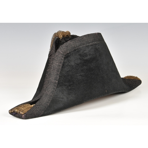 94 - Black felt Royal Navy midshipman's bicorn hat, owner's name inscribed indistinctly in ink inside , C... 