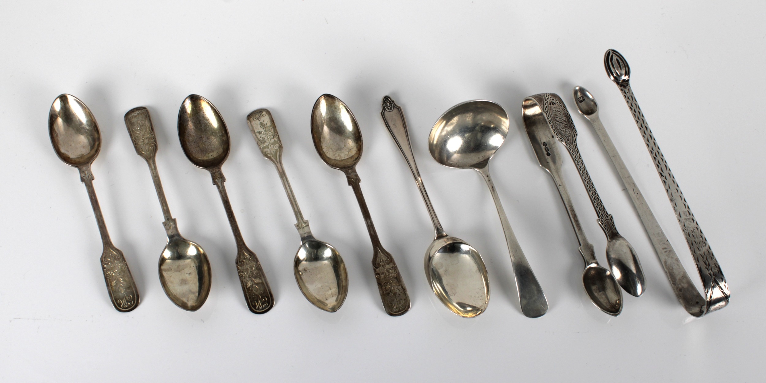 A collection of silver spoons and sugar tongs in various forms,, to ...