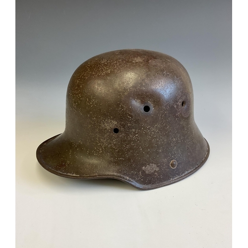 138 - A German WWI steel Stahlhelm helmet, reportedly a Somme relic, the helmet with bullet hole to side. ... 