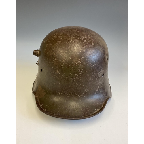 138 - A German WWI steel Stahlhelm helmet, reportedly a Somme relic, the helmet with bullet hole to side. ... 