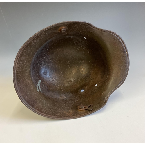 138 - A German WWI steel Stahlhelm helmet, reportedly a Somme relic, the helmet with bullet hole to side. ... 