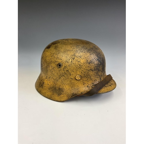 159 - A German World War Two (WWII) D.A.K desert camouflage Afrikakorps stahlhelm helmet, stamped Q64 & T7... 