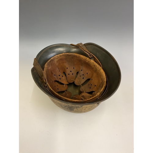 159 - A German World War Two (WWII) D.A.K desert camouflage Afrikakorps stahlhelm helmet, stamped Q64 & T7... 