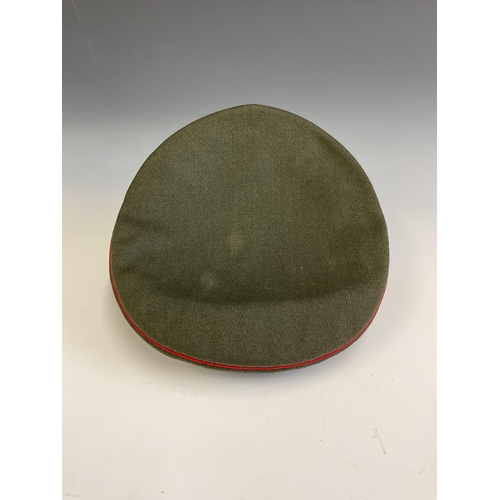 163 - A German Army World War Two Artillery Peaked Cap, red piping to the crown and bordering the central ... 