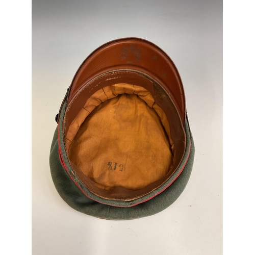163 - A German Army World War Two Artillery Peaked Cap, red piping to the crown and bordering the central ... 