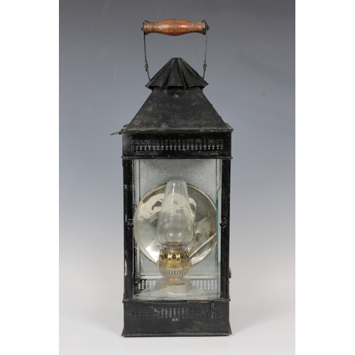 28 - A James Hicks and Sons Limited wooden cased metal storm lantern, possibly campaign, painted in black... 