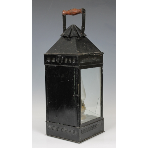 28 - A James Hicks and Sons Limited wooden cased metal storm lantern, possibly campaign, painted in black... 