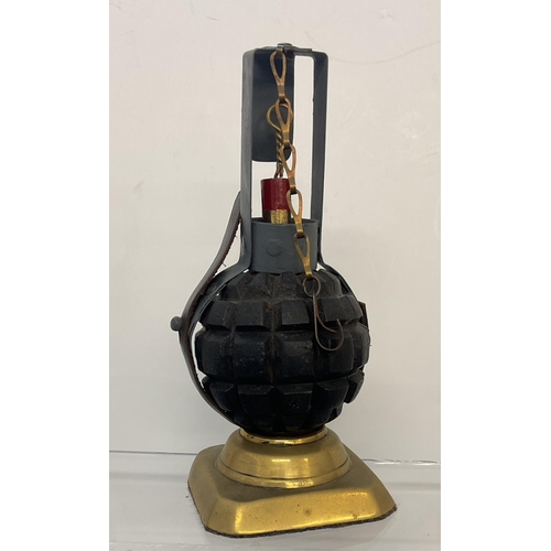 67 - WWI Imperial German INERT Kugel (ball) Grenade in a pannier with fuse, housed on later brass stand.