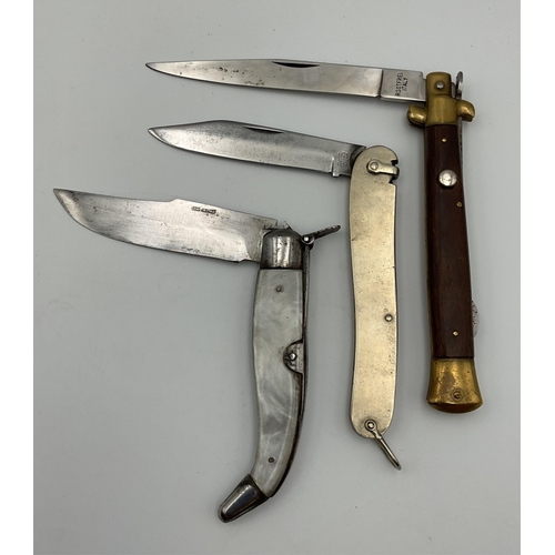90 - Three lock knives of varying forms, by Rostfrei, Italy; Otis-Albacete, Spain; Rodgers, England. (3)