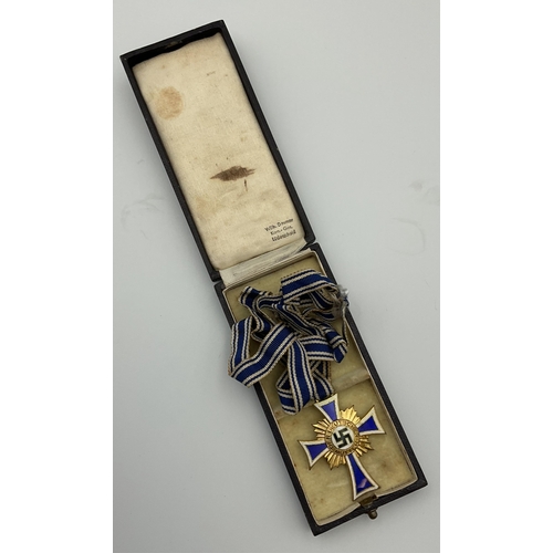 97 - A boxed German 'Der Deutschen Mutter' (German mothers cross) medal, cobalt blue enamel cross with wh... 