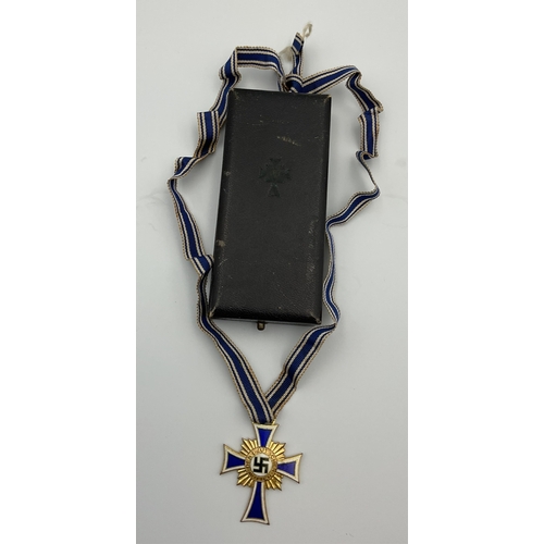 97 - A boxed German 'Der Deutschen Mutter' (German mothers cross) medal, cobalt blue enamel cross with wh... 