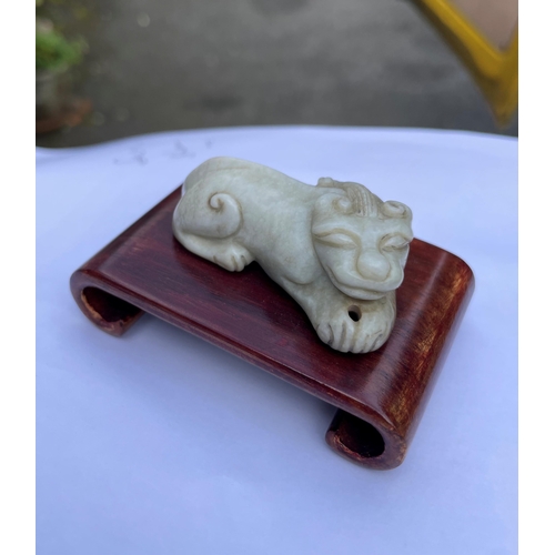 101 - A group of four Chinese carved hard stone figures, comprising of a carved white jade Chouyu having a... 
