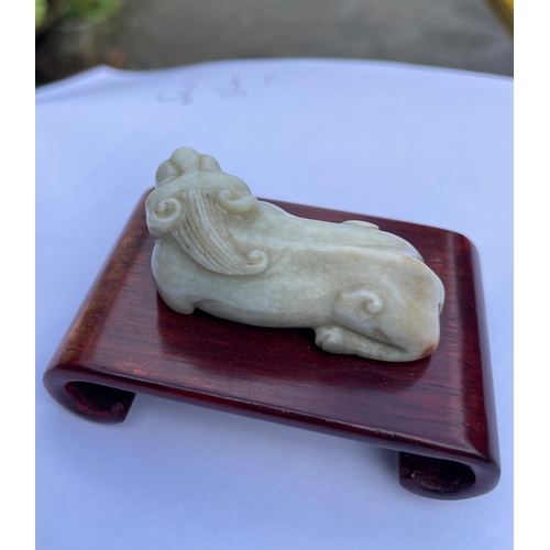 101 - A group of four Chinese carved hard stone figures, comprising of a carved white jade Chouyu having a... 