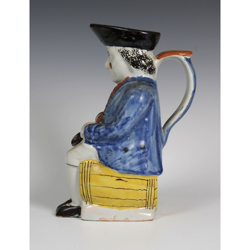 103 - An early 19th century Staffordshire pearlware Toby Jug of a gentleman, in 18th century dress seated ... 