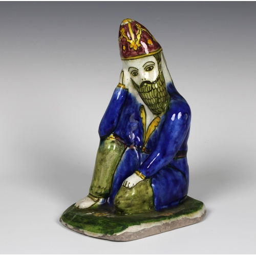104 - A Persian pottery statue of a Hakhamaneshi man, early 19th century, 23cm. high.Provenance: from The ... 