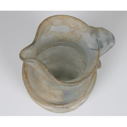 112 - An ancient Roman glass jug, possibly 3rd - 4th century CE, featuring a single loop handle and traile... 