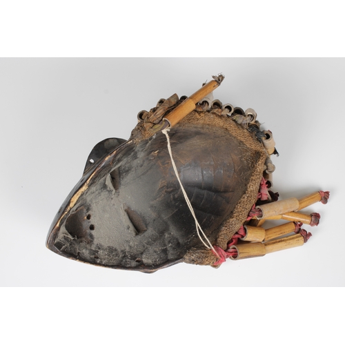 119 - An African carved wood and hand-painted Chokwe tribal mask, from Central Africa, the hair of cloth a... 