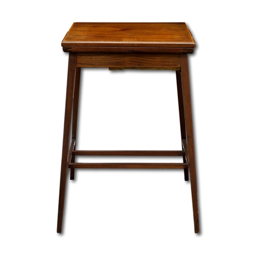 72 - An Edwardian mahogany writing table with twist and fold over top, with concealed storage compartment... 