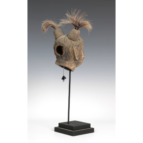 84 - A Burmese animated clay puppet head, with a wooden tongue and horse hair, on a stand, head 20cm. hig... 