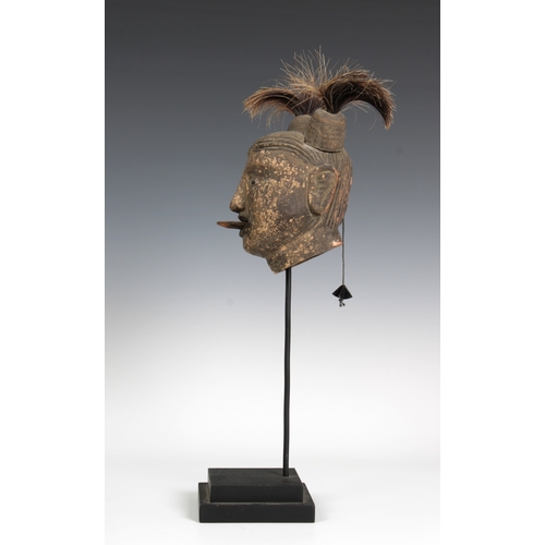 84 - A Burmese animated clay puppet head, with a wooden tongue and horse hair, on a stand, head 20cm. hig... 
