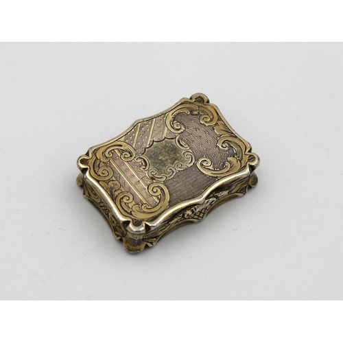 49 - A Victorian silver gilt shaped rectangular vinaigrette, Nathaniel Mills, Birmingham,1845, scroll & f... 