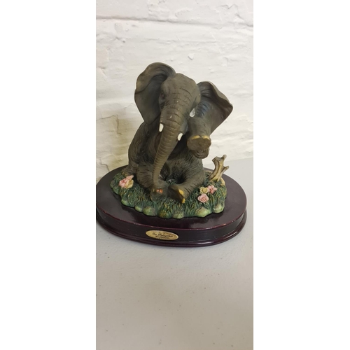 1020 - Elephant Figurine on a Wooden Plinth