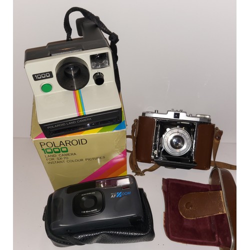 750 - A boxed Polaroid 1000 camera plus two other vintage cameras