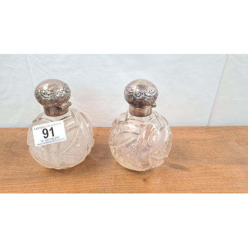 91 - Pair of Cut Glass Bottles with Silver Lids Birmingham 1900