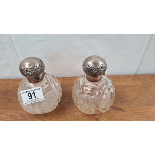 91 - Pair of Cut Glass Bottles with Silver Lids Birmingham 1900