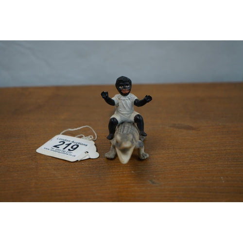 219 - A Rare Bisque Figurine of a Young Boy Riding a Crocodile