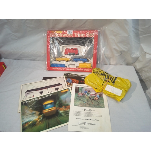 105 - Hornby clockwork train set box plus extra track and various magazines etc