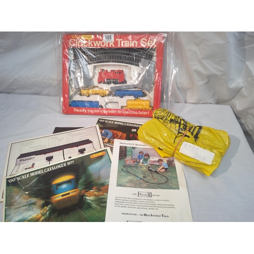 105 - Hornby clockwork train set box plus extra track and various magazines etc