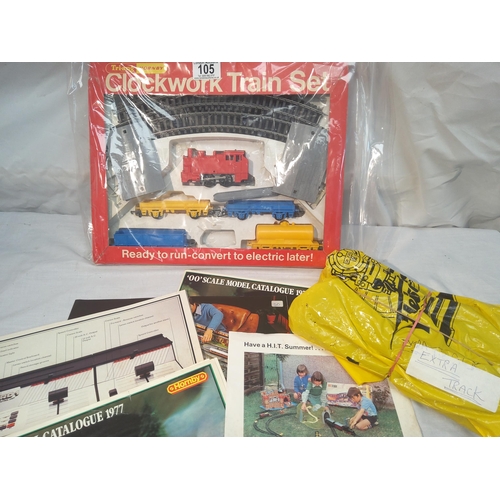 105 - Hornby clockwork train set box plus extra track and various magazines etc