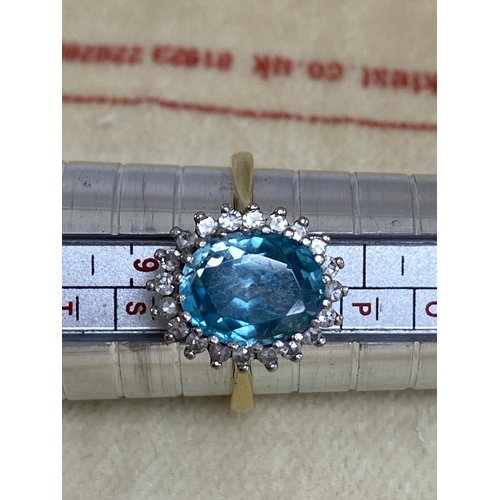 7 - 18ct Gold Aquamarine/Diamond Ring. Approx 2 carat with 20 Surrounding Diamonds. 5.6 Grams Size R