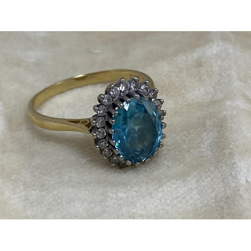 7 - 18ct Gold Aquamarine/Diamond Ring. Approx 2 carat with 20 Surrounding Diamonds. 5.6 Grams Size R