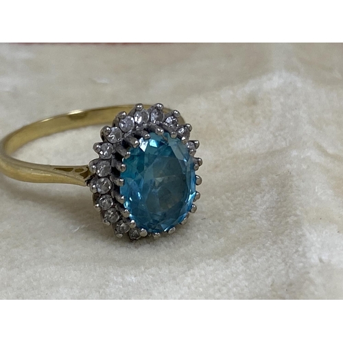 7 - 18ct Gold Aquamarine/Diamond Ring. Approx 2 carat with 20 Surrounding Diamonds. 5.6 Grams Size R