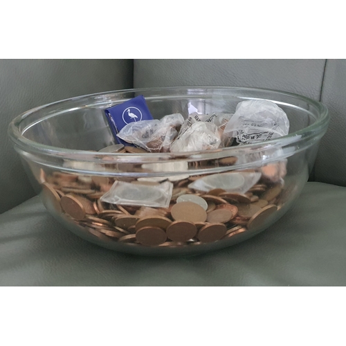 28 - Large glass bowl containing a large qty of coins including modern pennies, vintage coins, world coin... 