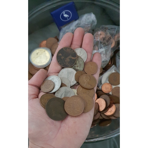 28 - Large glass bowl containing a large qty of coins including modern pennies, vintage coins, world coin... 