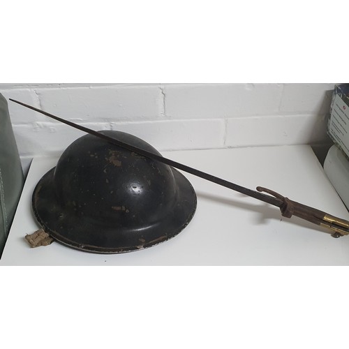 17A - A old military helmet plus a vintage bayonet