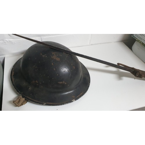 17A - A old military helmet plus a vintage bayonet