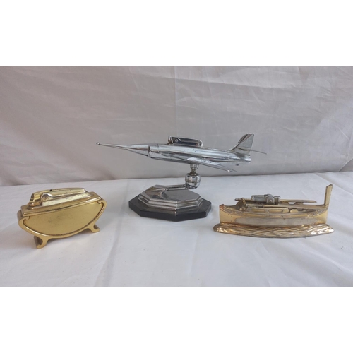 735 - Vintage Plane Form Lighter plus two other table lighters