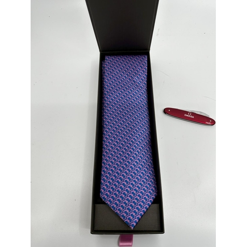 414 - New Patek Philippe Silk Tie and an Omega Pocket Knife