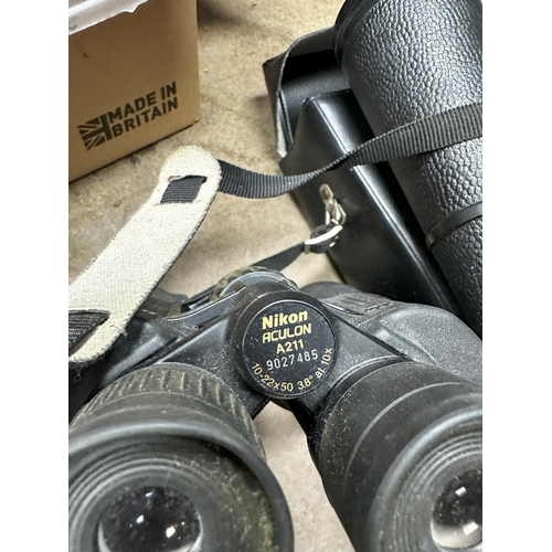 1342 - Pair of Kronos 20x60 binoculars in a case and a Pair of Nikon Aculon A211 Binoculars