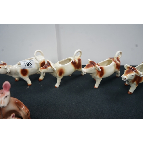 1198 - Four west German cow milkers and one novelty kangaroo salt and pepper shaker