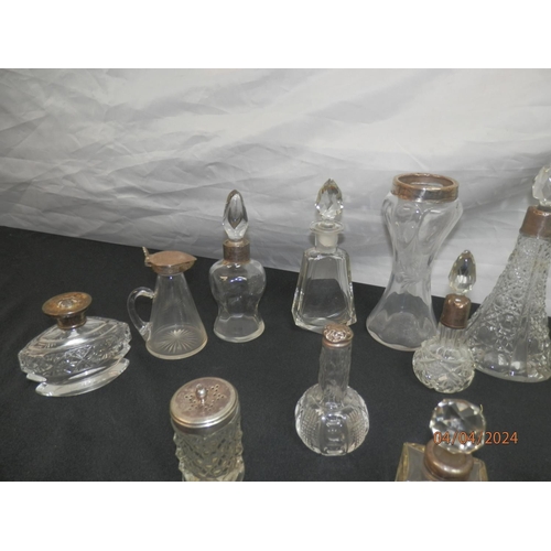 154 - Good Lot of Cut Glass Bottles mostly with Silver Collars